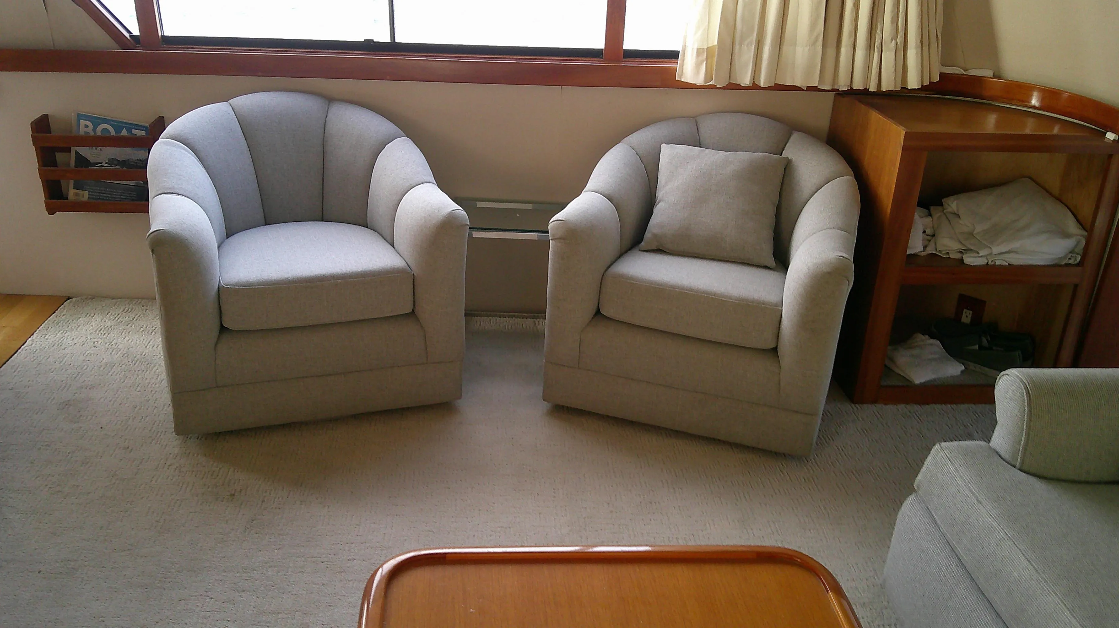 Interior of 1996 Ocean Alexander 546 Yachtfisher with two gray armchairs.
