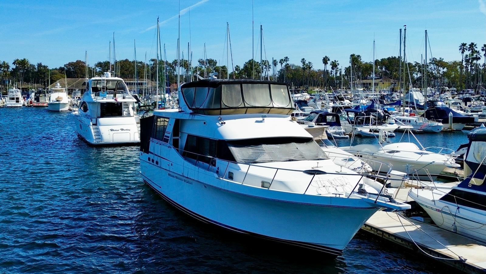 Ocean Alexander 546 Yachtfisher 1996 docked in a marina with other boats.
