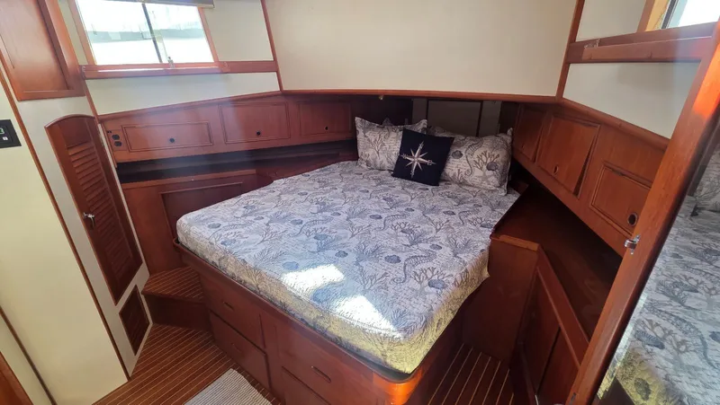 Cinsubar II Yacht Photos Pics Bedroom in 1997 Grand Banks 49 Classic with wooden furnishings.