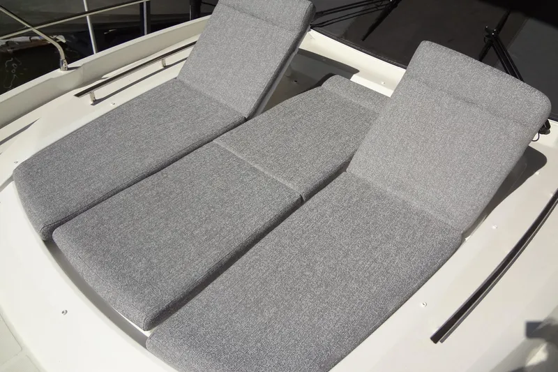 Dream Big Yacht Photos Pics Sunbathing lounge on 2023 Prestige 420S yacht, featuring adjustable gray cushions.