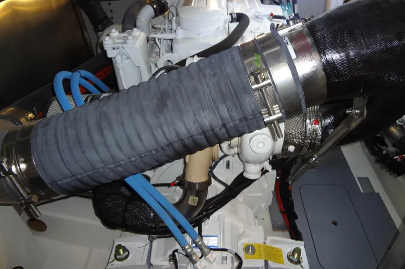 Dream Big Yacht Photos Pics Engine compartment of a 2023 Prestige 420S yacht, featuring hoses and mechanical components.