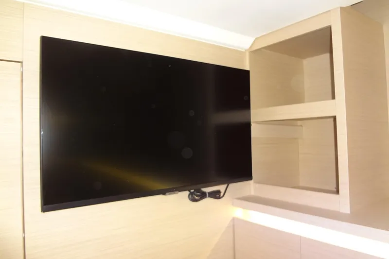 Dream Big Yacht Photos Pics 2023 Prestige 420S interior with mounted TV and wooden shelving.