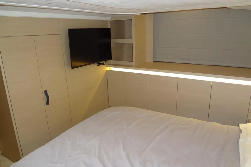 Dream Big Yacht Photos Pics Modern bedroom interior in 2023 Prestige 420S yacht with TV and sleek cabinetry.