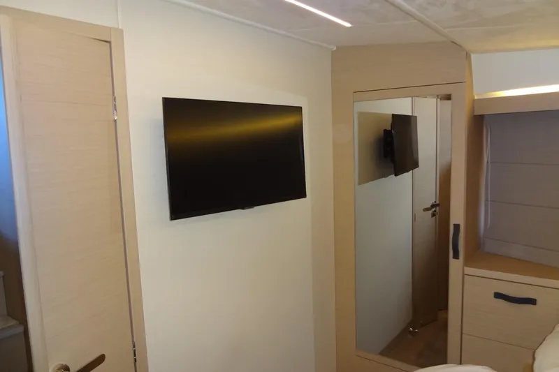 Dream Big Yacht Photos Pics Modern interior of 2023 Prestige 420S yacht with wall-mounted TV and mirror.