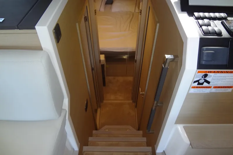 Dream Big Yacht Photos Pics Interior view of 2023 Prestige 420S yacht, featuring stairs leading to a cozy cabin.