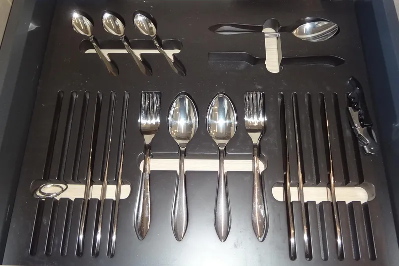 Dream Big Yacht Photos Pics Organized cutlery set in a drawer, featuring spoons, forks, and knives.