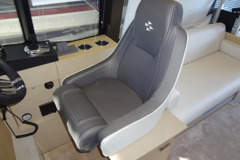 Dream Big Yacht Photos Pics Captain's seat in 2023 Prestige 420S yacht cockpit, featuring modern design and controls.