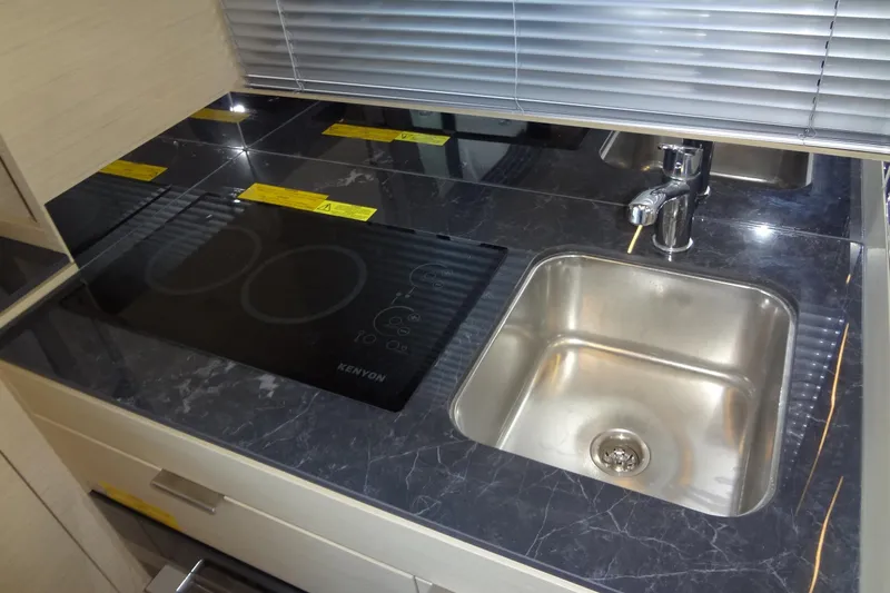 Dream Big Yacht Photos Pics Modern kitchen area in 2023 Prestige 420S yacht with stovetop and sink.
