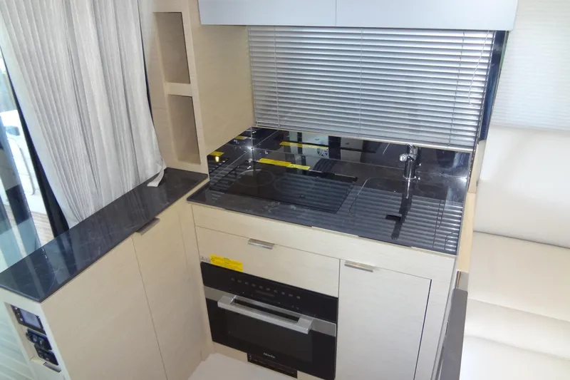 Dream Big Yacht Photos Pics Modern kitchen area in 2023 Prestige 420S yacht with sleek cabinetry and appliances.