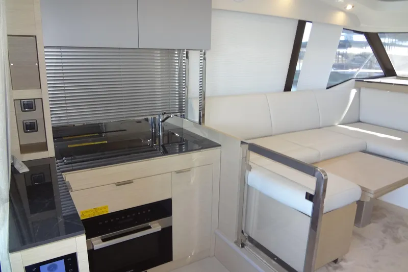 Dream Big Yacht Photos Pics Modern kitchen and seating area in 2023 Prestige 420S yacht interior.