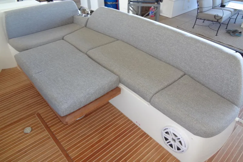 Dream Big Yacht Photos Pics 2023 Prestige 420S yacht interior with gray cushioned seating and wooden flooring.