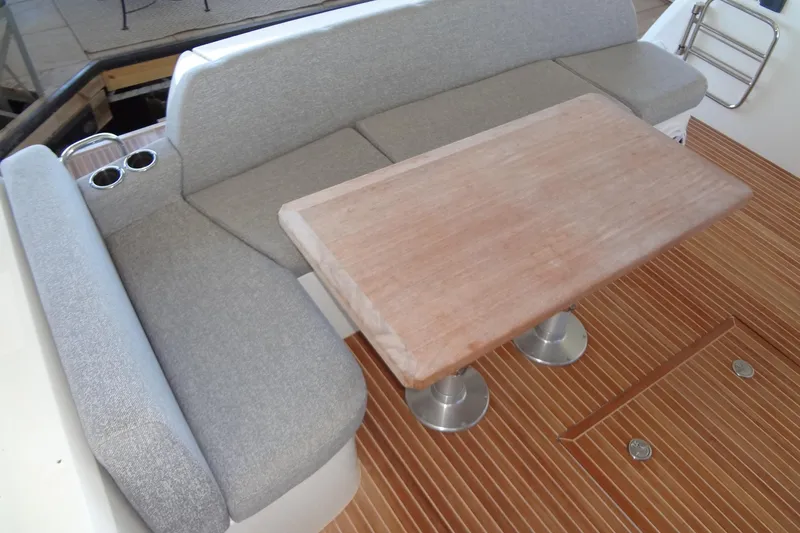 Dream Big Yacht Photos Pics 2023 Prestige 420S yacht interior with gray seating and wooden table.