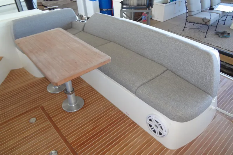 Dream Big Yacht Photos Pics 2023 Prestige 420S yacht interior with gray seating and wooden table.