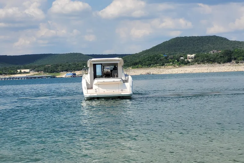 Dream Big Yacht Photos Pics Prestige 420S yacht cruising on a serene lake with scenic mountain backdrop.