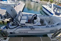 A 2022 Leopard 50 boat docked at a marina, featuring a Highfield tender.