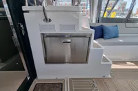Luxurious interior of 2022 Leopard 50 yacht with modern seating and stainless steel appliance.