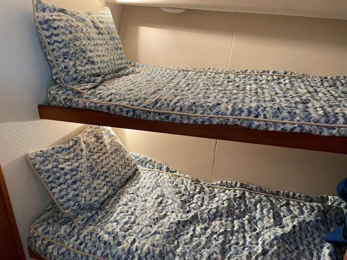 Tiramisu Yacht Photos Pics Bunk beds with patterned bedding in a 1996 Viking 47 Convertible yacht cabin.