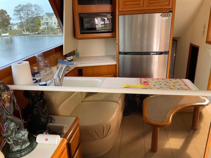 Tiramisu Yacht Photos Pics Interior of 1996 Viking 47 Convertible yacht with kitchen and seating area.