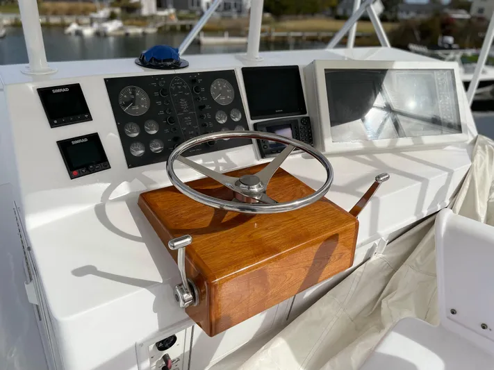 Tiramisu Yacht Photos Pics Steering console of a 1996 Viking 47 Convertible yacht with modern navigation instruments.