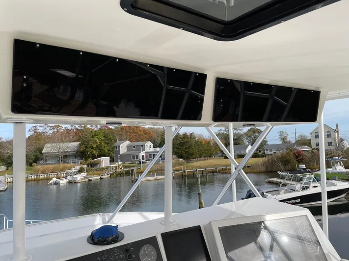 Tiramisu Yacht Photos Pics 1996 Viking 47 Convertible yacht helm with scenic waterfront view.