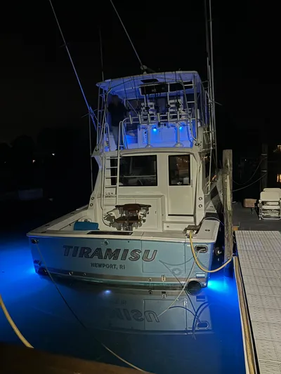 Tiramisu Yacht Photos Pics Viking 47 Convertible 1996 boat with blue underwater lights at night.