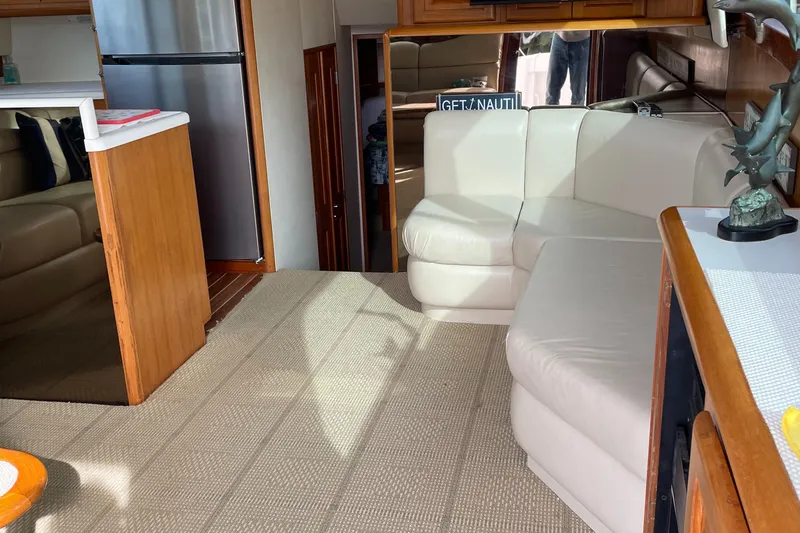 Tiramisu Yacht Photos Pics Interior of 1996 Viking 47 Convertible yacht with white leather seating and modern kitchen.