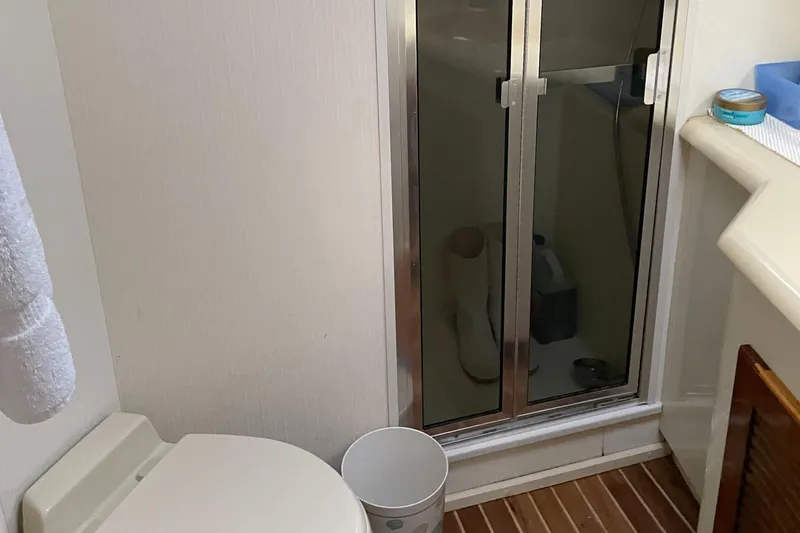Tiramisu Yacht Photos Pics Bathroom interior of 1996 Viking 47 Convertible yacht with shower and toilet.