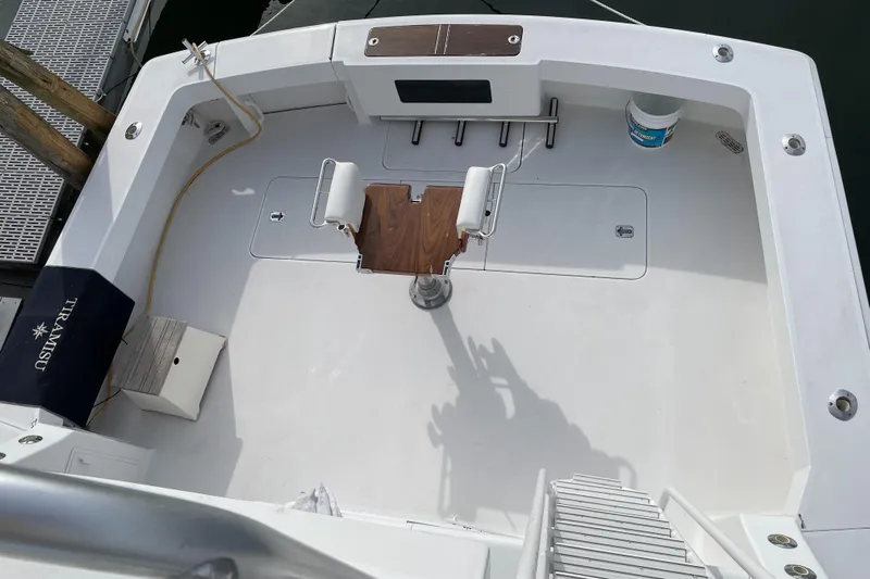 Tiramisu Yacht Photos Pics 1996 Viking 47 Convertible boat deck with fishing chair and clean white surface.