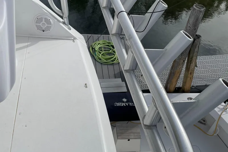 Tiramisu Yacht Photos Pics 1996 Viking 47 Convertible yacht deck with fishing rod holders and dock view.