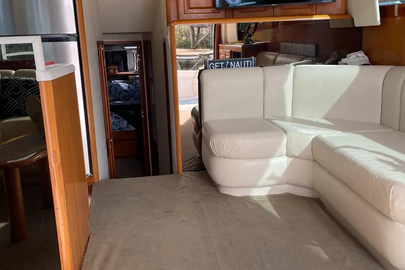 Tiramisu Yacht Photos Pics Interior of 1996 Viking 47 Convertible yacht with white leather seating and wood accents.