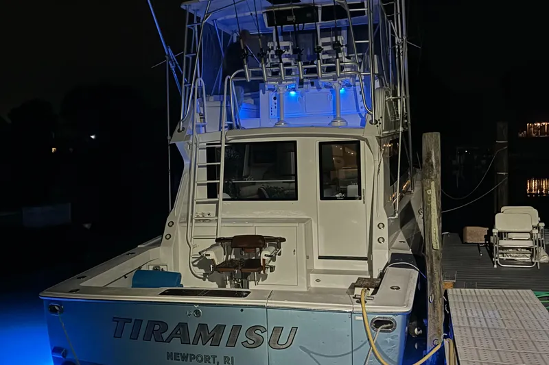 Tiramisu Yacht Photos Pics Viking 47 Convertible 1996 boat docked at night with blue lighting.