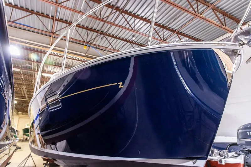 Mare Yacht Photos Pics 2018 MJM 35z boat in a warehouse, showcasing sleek blue hull design.