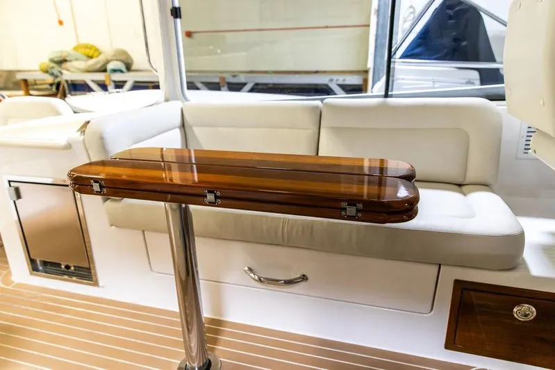 Mare Yacht Photos Pics Interior of 2018 MJM 35z boat with wooden table and white seating.