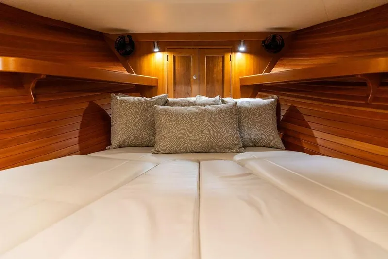 Mare Yacht Photos Pics Luxurious cabin interior of 2018 MJM 35z yacht with cozy bedding and wooden finish.