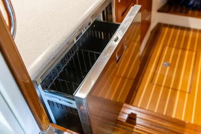 Mare Yacht Photos Pics Open drawer refrigerator in 2018 MJM 35z boat interior with wooden flooring.