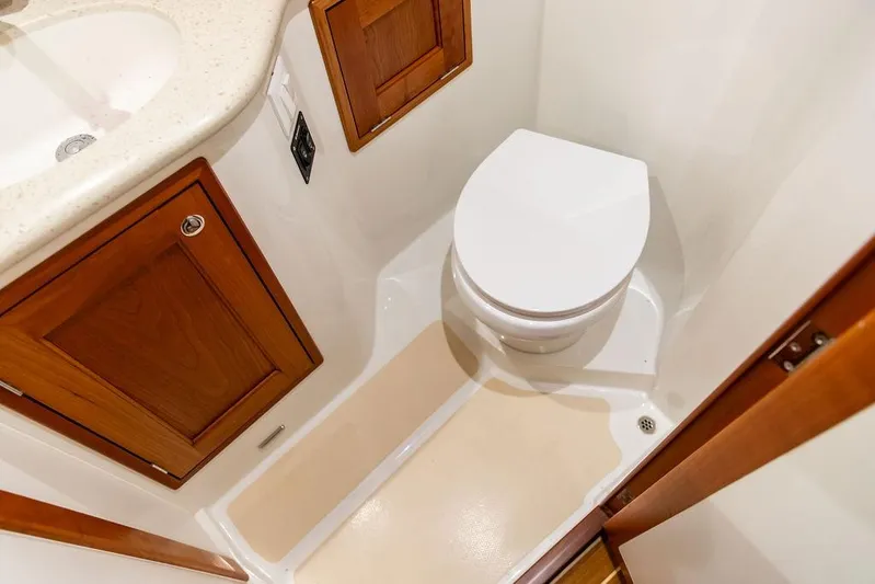 Mare Yacht Photos Pics 2018 MJM 35z boat bathroom with wooden cabinets and modern toilet.