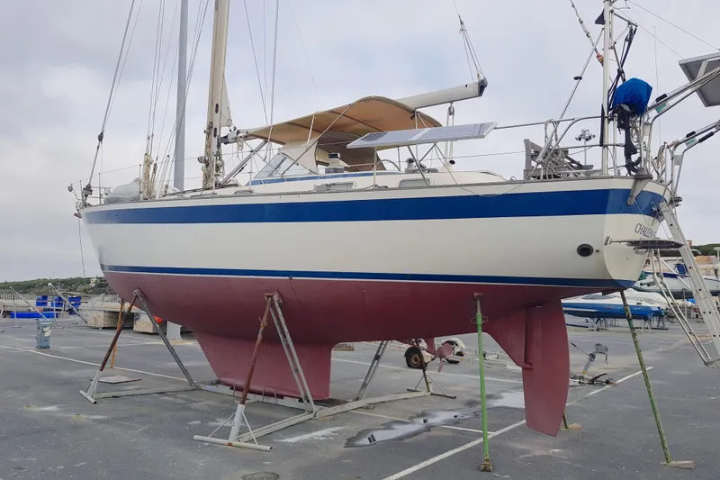 Challanger Yacht Photos Pics 1992 Hallberg-Rassy 45 sailboat on dry dock, featuring blue and white hull.