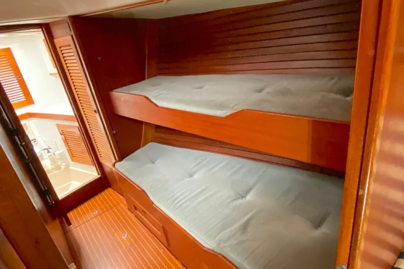 Challanger Yacht Photos Pics Interior of 1992 Hallberg-Rassy 45 yacht with wooden bunk beds and cozy cabin.