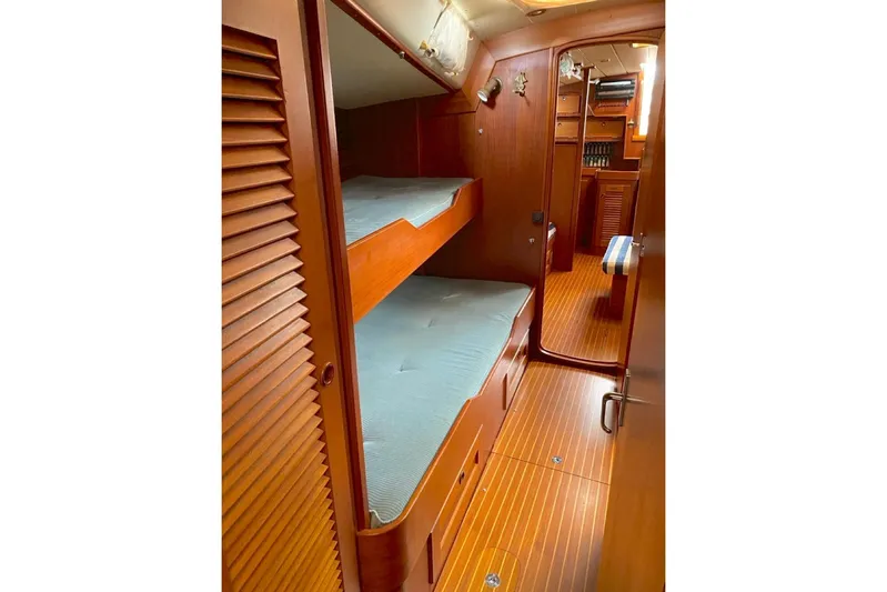 Challanger Yacht Photos Pics Interior of 1992 Hallberg-Rassy 45 yacht with wooden bunk beds and flooring.