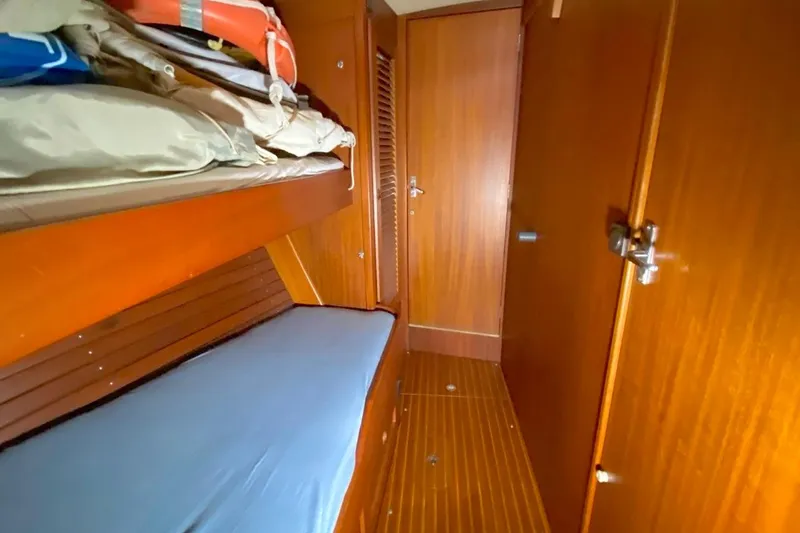 Challanger Yacht Photos Pics Interior of 1992 Hallberg-Rassy 45 sailboat with wooden paneling and bunk beds.