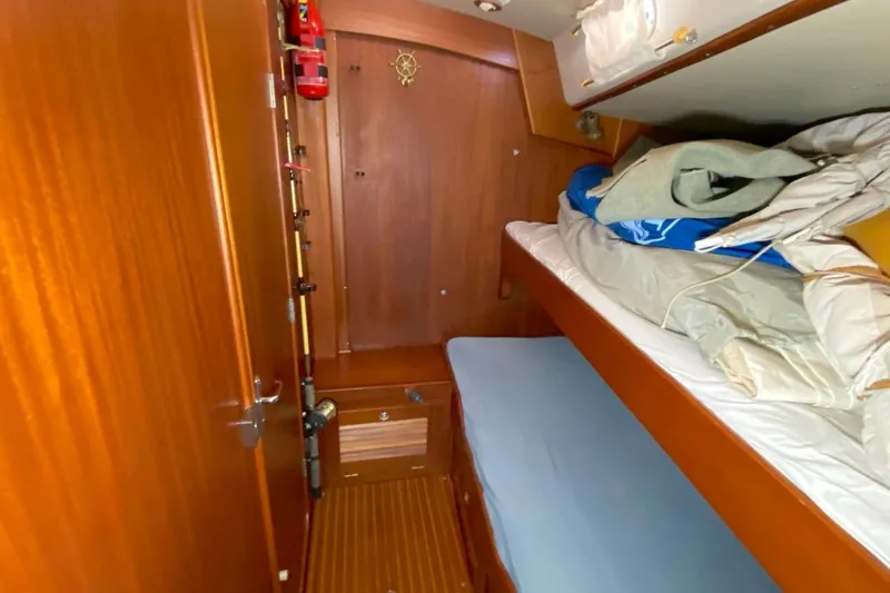 Challanger Yacht Photos Pics Interior cabin of 1992 Hallberg-Rassy 45 yacht with wooden finish and bunk beds.
