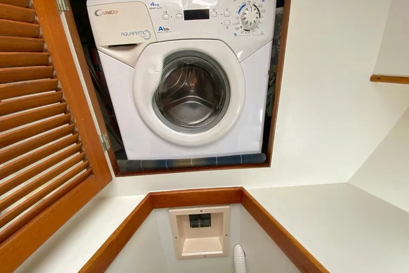 Challanger Yacht Photos Pics Washing machine in 1992 Hallberg-Rassy 45 yacht interior, wooden cabinet.
