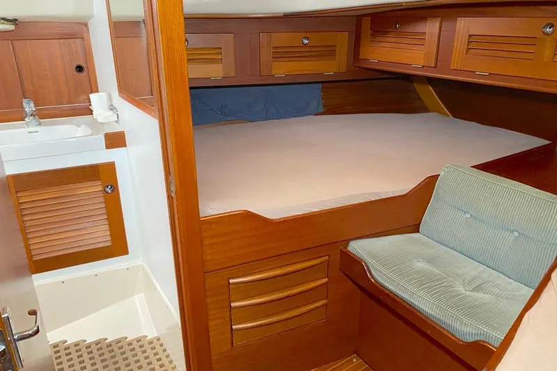 Challanger Yacht Photos Pics Cozy cabin interior of 1992 Hallberg-Rassy 45 yacht with wooden furnishings.