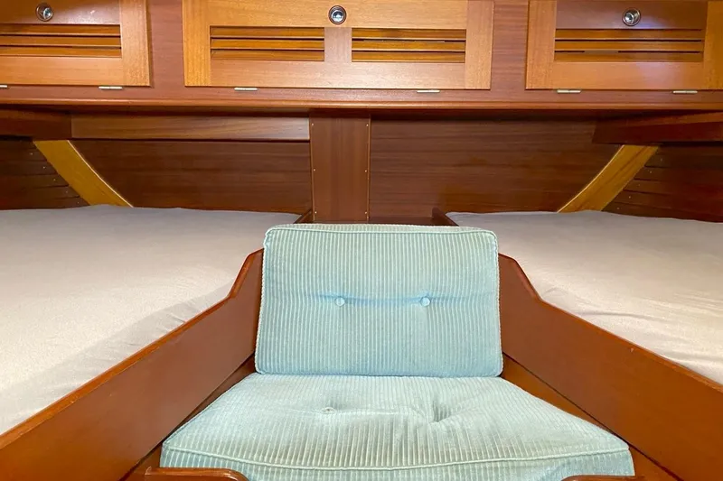 Challanger Yacht Photos Pics Interior of 1992 Hallberg-Rassy 45 yacht with wooden cabinetry and cushioned seating.