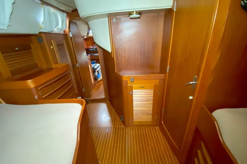 Challanger Yacht Photos Pics Interior of 1992 Hallberg-Rassy 45 yacht with wooden cabinetry and flooring.