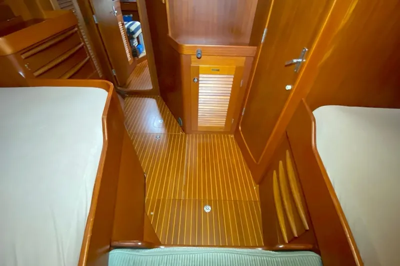 Challanger Yacht Photos Pics Interior of 1992 Hallberg-Rassy 45 yacht with wooden flooring and cozy cabin layout.