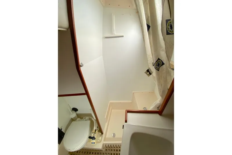 Challanger Yacht Photos Pics Bathroom interior of 1992 Hallberg-Rassy 45 yacht, featuring shower and toilet.