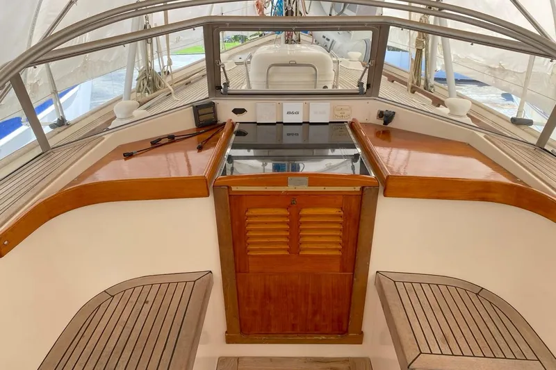 Challanger Yacht Photos Pics Cockpit of 1992 Hallberg-Rassy 45 sailboat with wooden seating and navigation equipment.