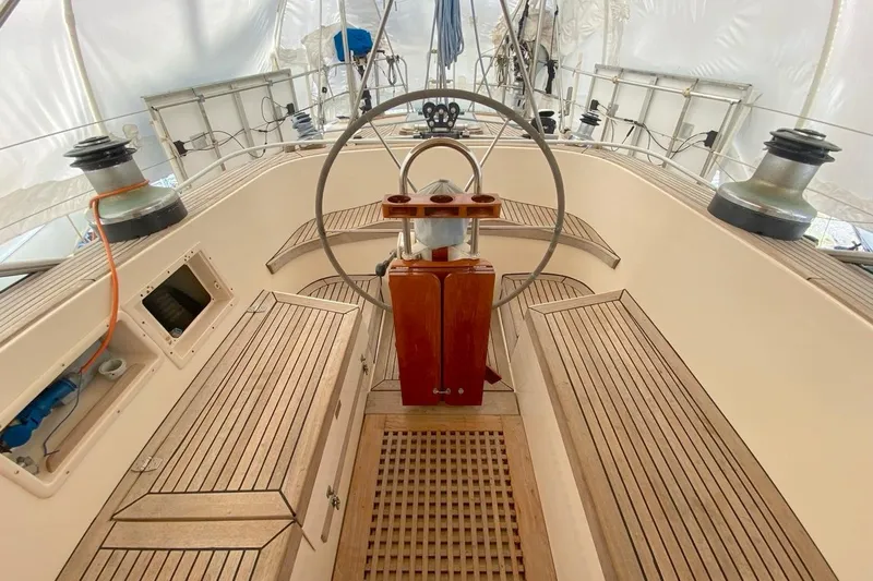 Challanger Yacht Photos Pics Cockpit of 1992 Hallberg-Rassy 45 sailboat with wooden seating and steering wheel.