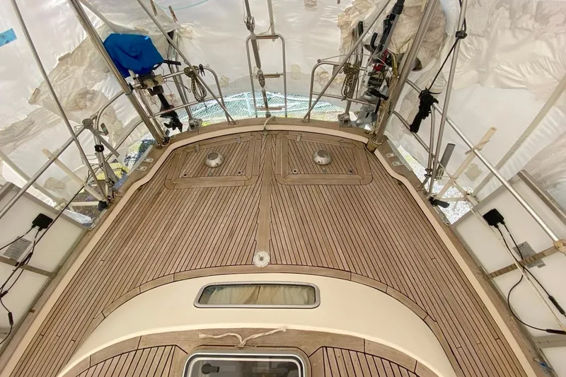 Challanger Yacht Photos Pics Deck of 1992 Hallberg-Rassy 45 sailboat with teak wood finish under protective cover.